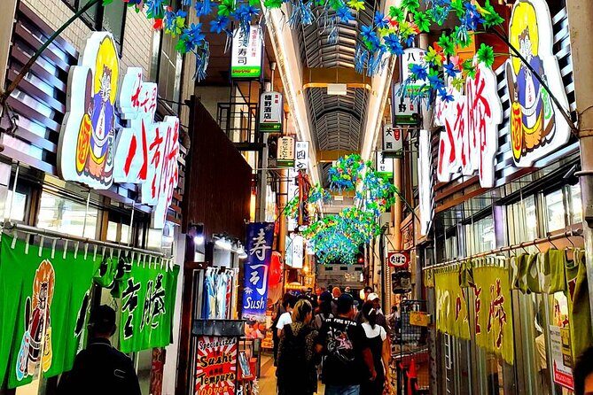 Hungry Osaka Street Food Tour:15 Tastings & 3 Drinks with a Local - Stop 1 in Shinsekai: Tsutenkaku and the Story Behind the Streets
