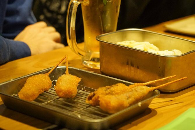 Osaka Local Foodie Walking Tour in Dotonbori and Shinsekai - Step into Shinsekai: Tsutenkaku, Jan-Jan Yokocho, and kushikatsu
